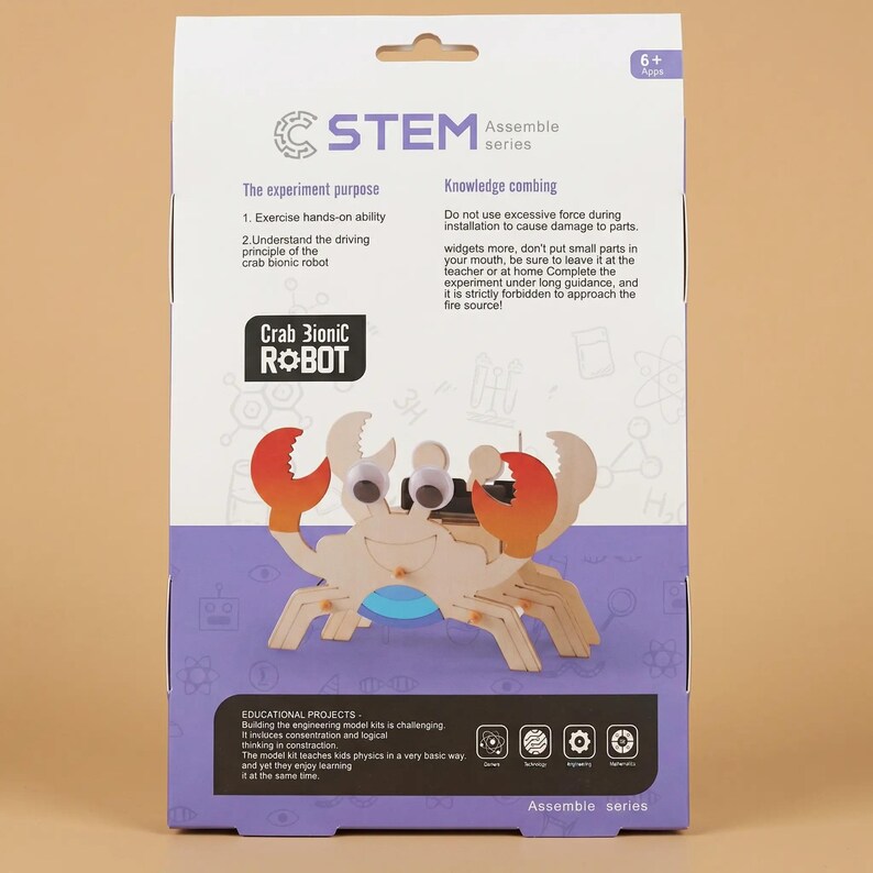 Peut inclure: Un kit STEM Assemble series avec un robot Crab Bionic. Le kit comprend des pi&egrave;ces en bois, des yeux globuleux et des pinces rouges et orange. La bo&icirc;te contient du texte sur le but de l'exp&eacute;rience et les projets &eacute;ducatifs.