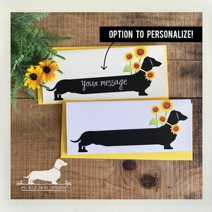 May include: Greeting cards featuring a black dachshund silhouette adorned with sunflowers. The cards have a yellow border and a white interior with the option to personalize the message. The text "OPTION TO PERSONALIZE!" is displayed.