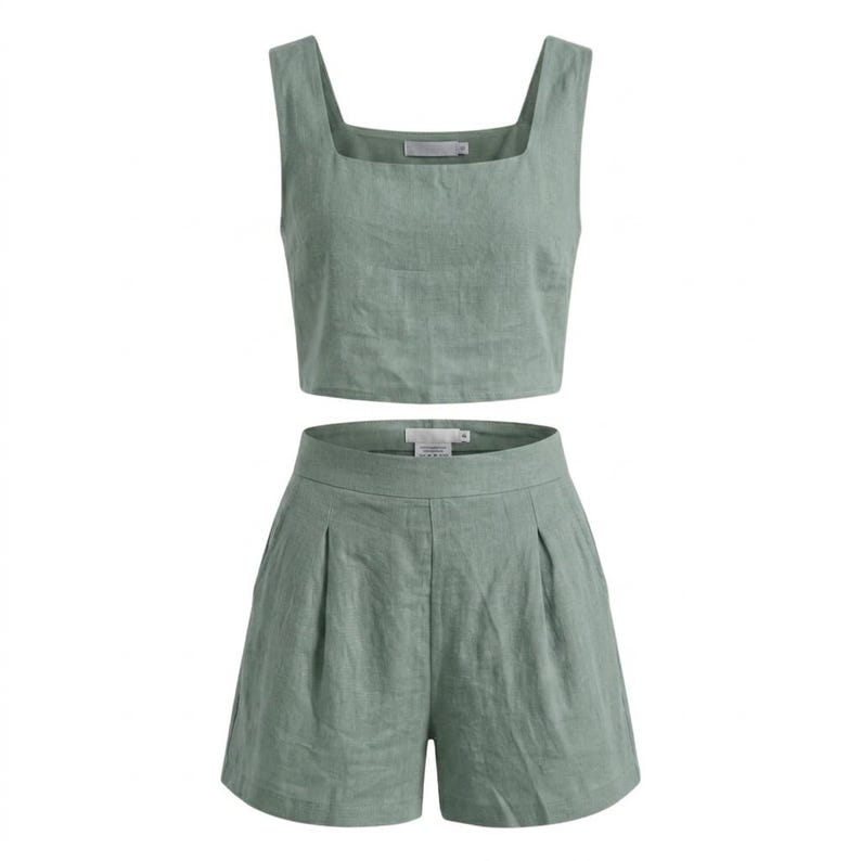 May include: Sage green two-piece outfit. The set includes a square-neck crop top and high-waisted shorts. The shorts have pleats in the front. The fabric appears to be linen or a similar lightweight material. The outfit is designed for warm weather.
