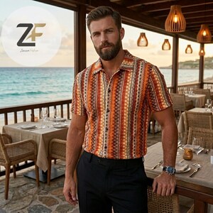 May include: Short-sleeved button-down shirt with a geometric pattern in shades of orange, brown, and cream. The shirt is paired with black dress pants. The image is taken outdoors, with a beach and restaurant setting in the background.
