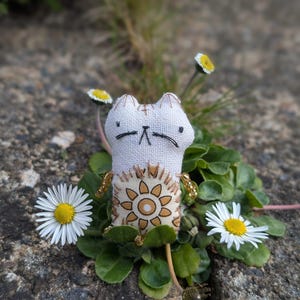 May include: A set of three ceramic mugs with a speckled, matte finish in cream, light grey, and dark grey. Each mug has a simple, minimalist design, suitable for coffee or tea.