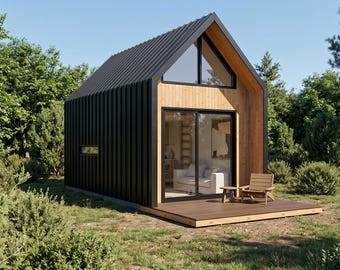May include: A small cabin with a black corrugated metal roof and exterior walls, featuring light wood paneling on the front facade, a large glass sliding door, a triangular window at the peak, and a wooden deck with a chair and small table.