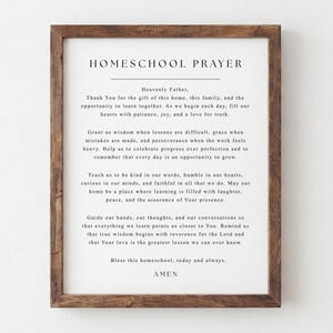 May include: A framed wall art print featuring the text HOMESCHOOL PRAYER in black serif font on a white background. The prayer includes verses about wisdom, patience, and learning, enclosed in a dark brown wooden frame with a visible wood grain texture.