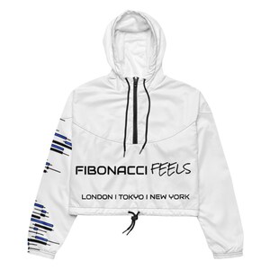 May include: White cropped windbreaker jacket with a hood and black zipper. The jacket features the text "FIBONACCI FEELS" in black, with "LONDON I TOKYO I NEW YORK" below. The left sleeve has a blue and black graphic design.