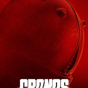 May include: A red-toned image featuring a close-up of a futuristic helmet, with the text "CRONOS THE NEW DAWN" in white block letters. The words "DELUXE EDITION" are at the top.