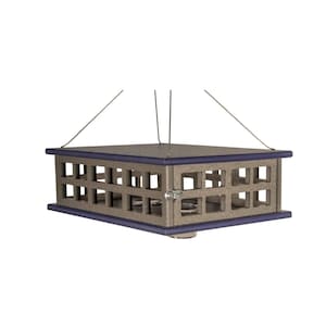 May include: A square bird feeder with a gray body and a dark blue trim. The feeder has a series of square cutouts on the sides and is suspended by thin wires. A small metal latch is visible on the side.