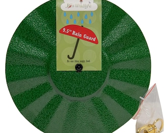 May include: Green 9.5 inch rain guard for bird feeders. The rain guard is shaped like an umbrella and has a black hook for hanging. The text on the label reads "Jo's Wildlife 9.5" Rain Guard No one likes soggy food."