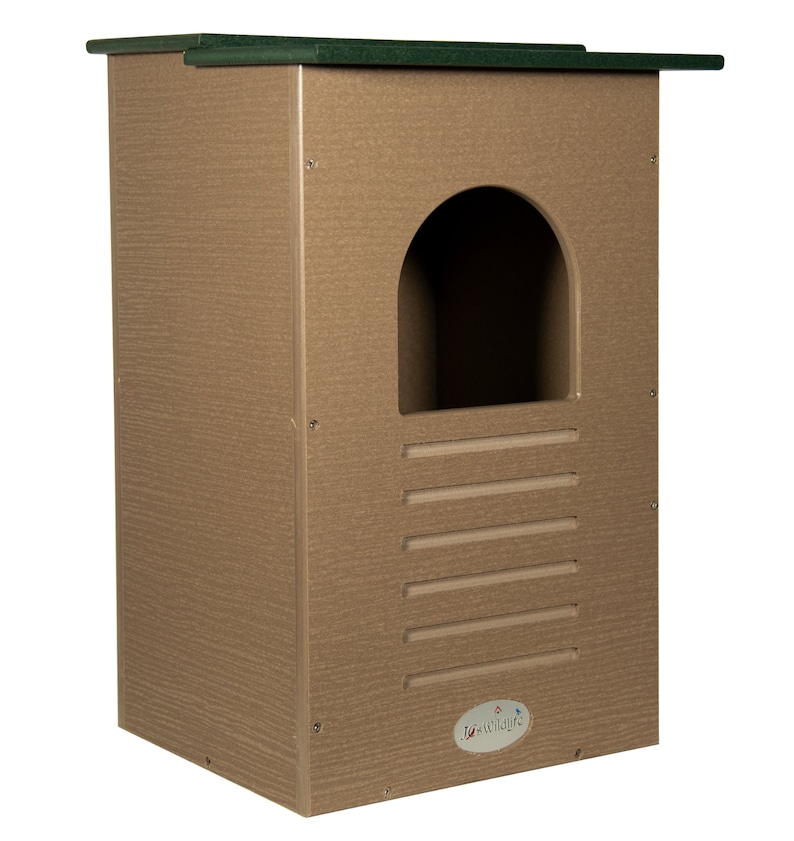 May include: A rectangular birdhouse with a textured, light brown finish and a dark green roof. It features a rounded entrance and horizontal ventilation slots. The birdhouse has the "Jo-Wild" logo on the lower right.