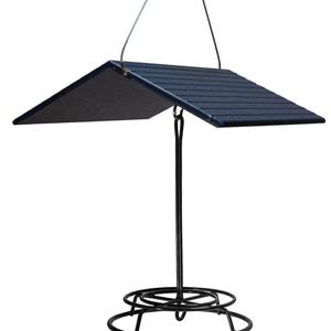 May include: A black metal bird feeder with a blue plastic roof. The feeder has a round base and a hanging hook.