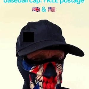 May include: A person wearing a black baseball cap and a face mask featuring a skull design in red, white, and blue. The text "UK Facemask with a FREE baseball cap" is visible at the top of the image.