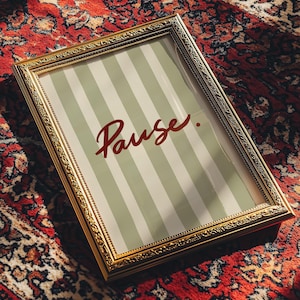 May include: A rectangular wall art print in an ornate gold frame featuring a sage green and white vertical striped background with the word Pause written in a dark red cursive script font centered on the print, creating a decorative display piece.