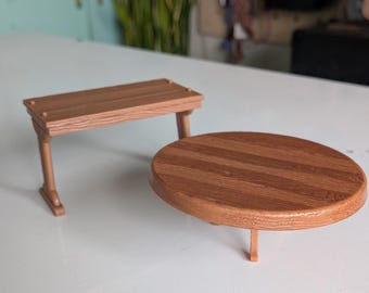 May include: A miniature brown plastic rectangular bench with a wood grain texture and a matching miniature brown plastic round table with a wood grain texture. Both items feature simple structural legs and a smooth, molded finish throughout.