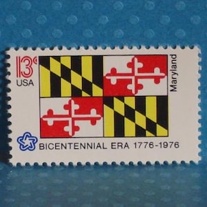 May include: A vintage postage stamp featuring the Maryland state flag design. The stamp has a white background with the Maryland flag in the center, the text "13¢ USA" and "BICENTENNIAL ERA 1776-1976". The stamp is rectangular with a perforated edge.
