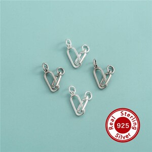 May include: Four silver-colored metal jewelry connectors, each featuring an elongated oval link attached to a smaller circular jump ring. A circular red and white badge in the corner displays the text Real Sterling Silver 925.