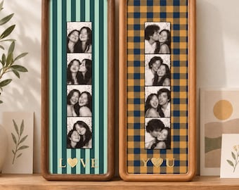 May include: Two vertical wooden picture frames containing photo strips. The left frame has a teal striped background with the word LOVE and a heart icon. The right frame has a yellow and navy plaid background with the word YOU and a heart icon.