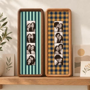 May include: Two vertical wooden picture frames containing photo strips. The left frame features a light green and dark green striped background, while the right frame has a navy blue and mustard yellow plaid background. Each holds four black-and-white photos.