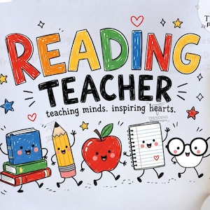 May include: A white sweatshirt featuring the colorful text READING TEACHER and the phrase teaching minds. inspiring hearts. The design includes cartoon illustrations of a blue book, a yellow pencil, a red apple, a notebook, and white glasses.