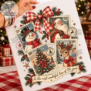 May include: A white canvas featuring a Christmas-themed collage of four postage stamp illustrations: a snowman, Santa Claus, a decorated Christmas tree, and a reindeer. A red and white gingham bow sits at the top, with the text "it's the most wonderful time of the year" on a banner at the bottom.