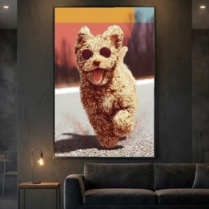 Puede incluir: Impresión enmarcada de un perro corriendo con gafas de sol. El perro está representado en un estilo texturizado, marrón dorado, con la lengua fuera. El fondo presenta un diseño de bloques de color con tonos naranja, amarillo y azul.