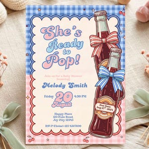 May include: A rectangular baby shower invitation card featuring a blue and pink gingham border with a scalloped edge. The text reads She's Ready to Pop! honoring Melody Smith on Friday 20 August at 4:30 PM. Two soda bottles with bows are illustrated on the right side.