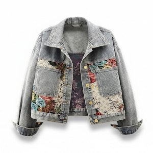 May include: A white ceramic mug with a black handle and the text "But First, Coffee" in a bold, black font. The mug is set against a blurred background, suggesting a cozy setting.