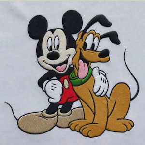 Könnte beinhalten: Ein gestickter Aufnäher auf weißem Stoffhintergrund mit Mickey Maus und Pluto. Mickey hat schwarze Ohren, ein cremefarbenes Gesicht, eine rote Hose und gelbe Schuhe. Pluto ist hellbraun mit grünem Halsband, schwarzen Ohren und rosa Zunge.