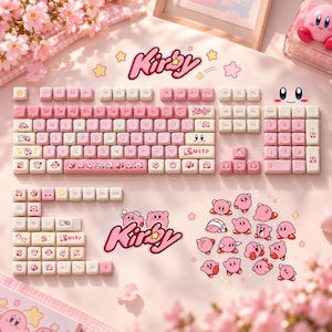 May include: A mechanical keyboard keycap set featuring a pink and cream color scheme with Kirby character graphics. The set includes a full QWERTY layout, a number pad, function keys, and various decorative keys with Kirby illustrations and logos.