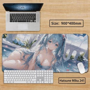May include: A large rectangular mousepad featuring an anime-style illustration of a woman with long, light blue hair. The mousepad is 35.4 x 15.7 inches and includes the text "Hatsune Miku 241". A laptop, keyboard, and mouse are also visible.