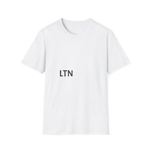 May include: A plain white short-sleeved t-shirt featuring a crew neckline. The front of the garment displays the letters LTN printed in a simple, bold, black sans-serif font positioned on the left side of the chest area.