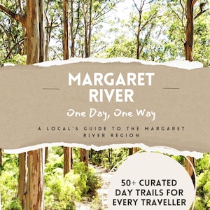 May include: A travel guide book cover titled Margaret River One Day, One Way, A Local's Guide to the Margaret River Region, featuring a background of tall eucalyptus trees and a dirt path, with a circular badge stating 50+ Curated Day Trails For Every Traveller.
