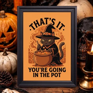May include: A framed rectangular print on an orange background featuring a black cat wearing a witch hat and robe, stirring a brown cauldron. The text reads: THAT'S IT. YOU'RE GOING IN THE POT. The illustration includes swirling smoke effects.