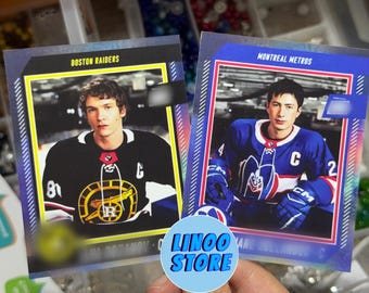 May include: Two rectangular sports trading cards featuring hockey players. The left card is labeled Boston Raiders and shows a player in a black jersey. The right card is labeled Montreal Metros and shows a player in a blue jersey with a large letter C.