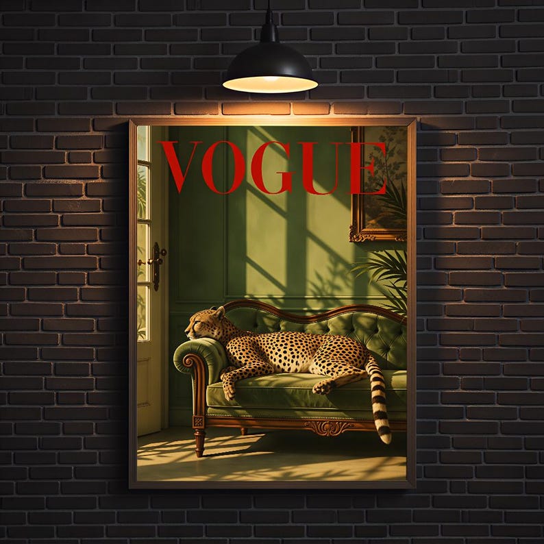 May include: A rectangular wall art print featuring a cheetah resting on a green velvet sofa. The word VOGUE is printed in large red capital letters at the top. The scene includes a doorway, a framed picture, and shadows cast by sunlight.
