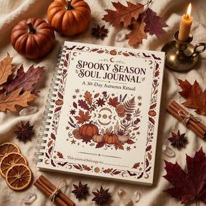 May include: A spiral-bound journal with a cream cover titled Spooky Season Soul Journal A 30-Day Autumn Ritual. The cover features illustrations of pumpkins, autumn leaves, crystals, and moon phases. The text This journal belongs to is printed at the bottom.
