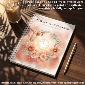 May include: A spiral-bound 12-week year planner with a white cover featuring a watercolor illustration of a clock surrounded by a wreath of pink and orange flowers and foliage. The text reads 12 WEEK YEAR PLANNER Bloom Into Your Best Self.