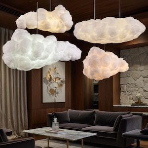 May include: A white ceramic mug with a black handle and the text "But First, Coffee" in a black, bold font. The mug is on a white surface. The mug is approximately 4 inches tall.