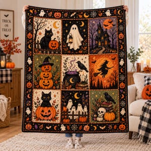 May include: A rectangular throw blanket featuring a grid of nine Halloween-themed illustrations including black cats, pumpkins, ghosts, a haunted house, a witch on a broomstick, a cauldron, a raven, and a skull, all framed by a black border with icons.