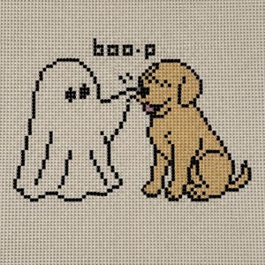 May include: A needlepoint canvas featuring a white ghost touching the nose of a tan dog with the text "boo-p" above them. The border is printed with the repeating text "Blake House of Dogs" and the logo, with "bhod" in the corner.
