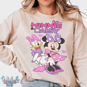 May include: A set of three ceramic mugs with a speckled, matte finish. Each mug features a different color: light blue, cream, and gray. The mugs have a simple, modern design and a comfortable handle.