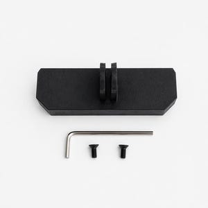 May include: A black rectangular mounting bracket with two vertical slots, a hex key, and two black screws. The bracket is designed for attaching to a surface. The items are arranged on a white background.