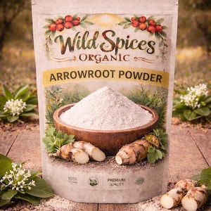 May include: A packet of Wild Spices Organic Arrowroot Powder. The packaging features a design with red berries and green leaves. A wooden bowl filled with white powder is in front of the packet, with arrowroot roots and leaves around it.