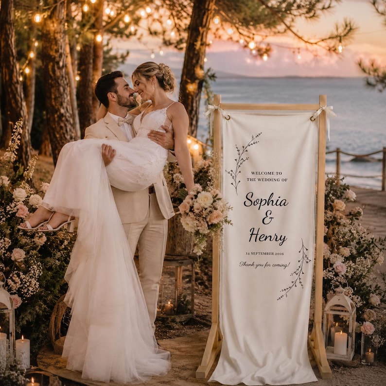 Elegant wooden wedding welcome sign with custom fabric banner, outdoor garden ceremony entrance decor, personalized wedding reception signage