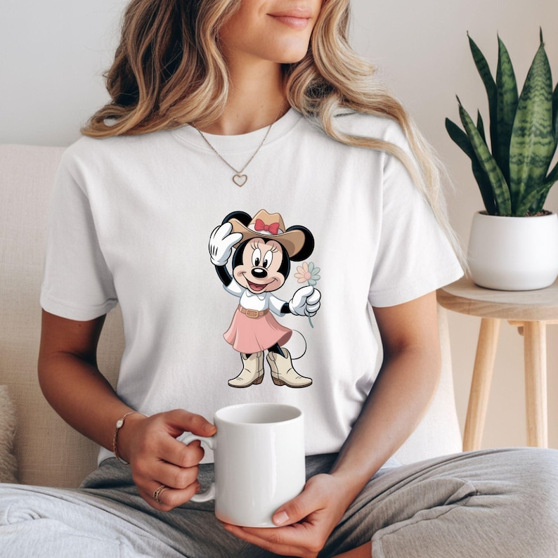 May include: A white ceramic mug with a black handle and the text "But First, Coffee" in a black, handwritten-style font. The mug is on a white surface.