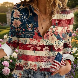 May include: A long-sleeve button-down shirt featuring a patriotic American flag design with floral patterns, a bald eagle emblem, and the text 1776-2026 250 Years. The shirt has a V-neckline, white buttons, and a distressed red, white, and blue color palette.