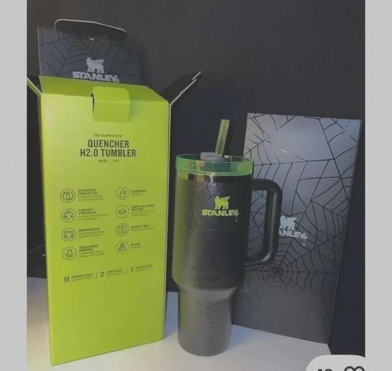 May include: Black Stanley Quencher H2.0 tumbler with a green lid and straw. The tumbler has a handle and the Stanley logo. The box is lime green and black with the text "QUENCHER H2.0 TUMBLER".