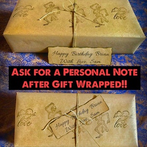 May include: Two brown paper gift boxes wrapped with twine and decorated with a skeleton dancing graphic and the text "handmade with love". The boxes are tied with twine and have a handwritten tag that reads "Happy Birthday Brian With Love, Sam".