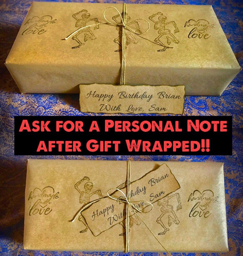 May include: Two brown paper gift boxes wrapped with twine and decorated with a skeleton dancing graphic and the text "handmade with love". The boxes are tied with twine and have a handwritten tag that reads "Happy Birthday Brian With Love, Sam".