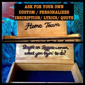 May include: A wooden box with a hinged lid. The lid is engraved with the words "Home Team". The inside of the box is lined with blue velvet. The bottom of the box is engraved with the lyrics "Boogie on Reggae woman, what you tryin' to do?"
