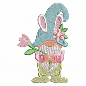 以下が含まれることがあります： 水色の帽子とウサギの耳を持つ刺繍されたノームのデザイン。ピンクの花と緑の茎を持っています。ノームは桃色の鼻とひげがあり、ピンクと緑のアクセントがあります。