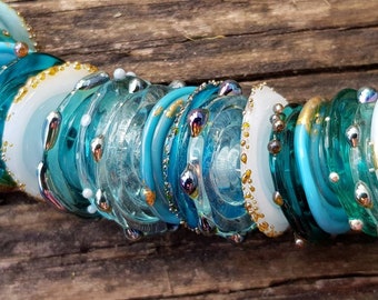 Organic style handmade lampwork murano glass disc beads in shades of aqua, teal and turquoise with 24k gold leaf, droplet and frit texture